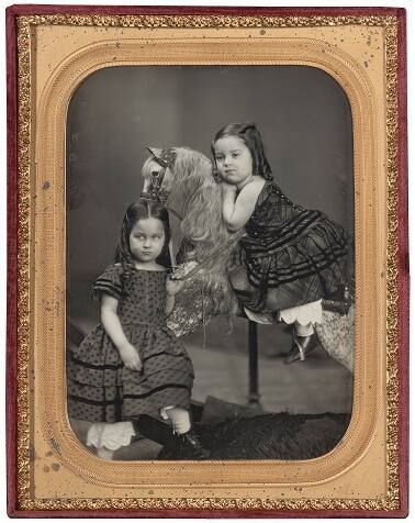 Two Girls on a Hobby Horse