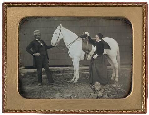 Woman with horse and groom