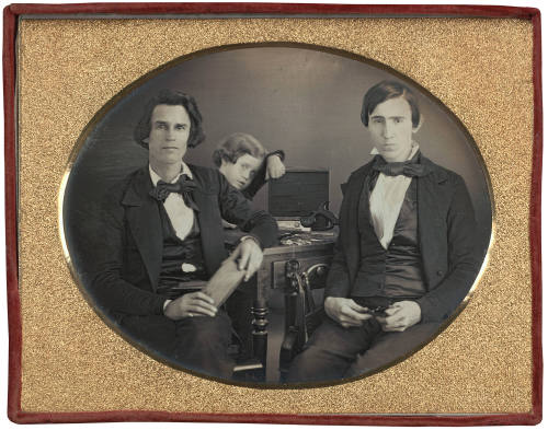 Two musical instrument repairmen and young boy