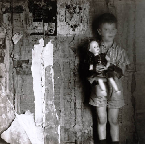 [Boy with doll in interior]