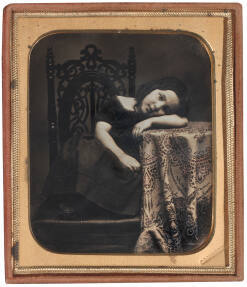 Girl Resting Head on Table
