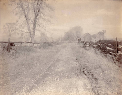 Untitled (field with road and fences)