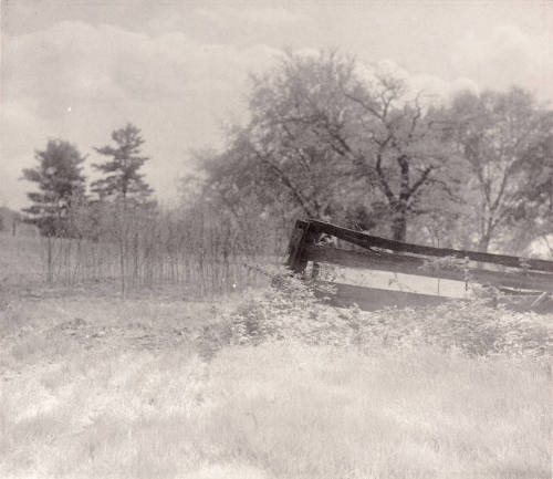 Untitled (broken fence in field)
