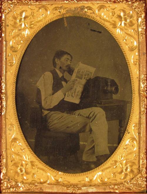 Man with Newspaper and Camera