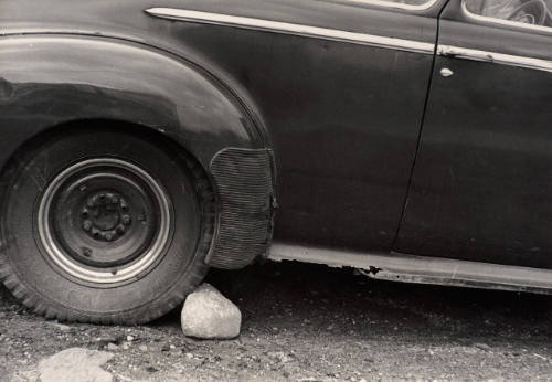 Untitled (Stone Holding Car Wheel)