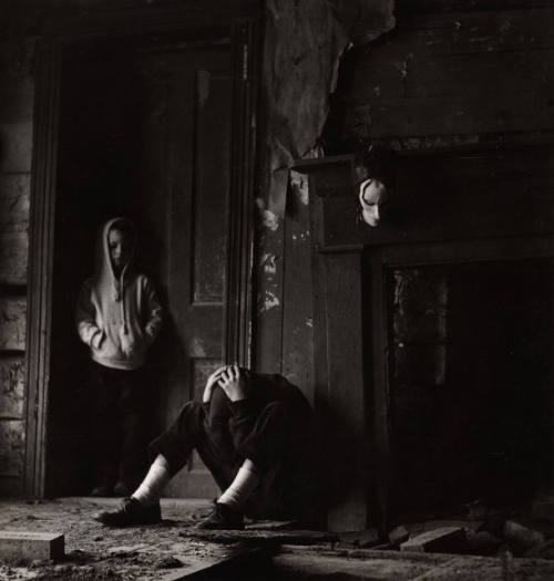 [Two boys in interior with mask on wall]