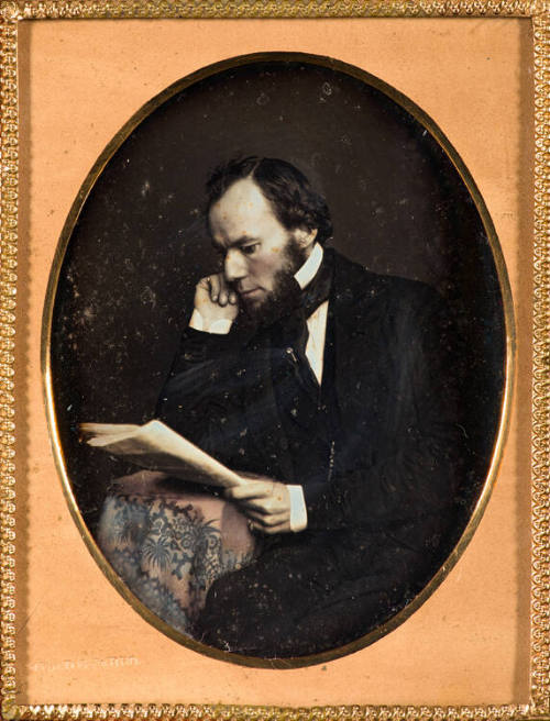 Man in profile reading