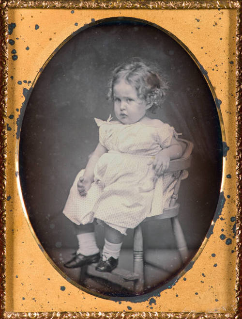 Portrait of child in high chair