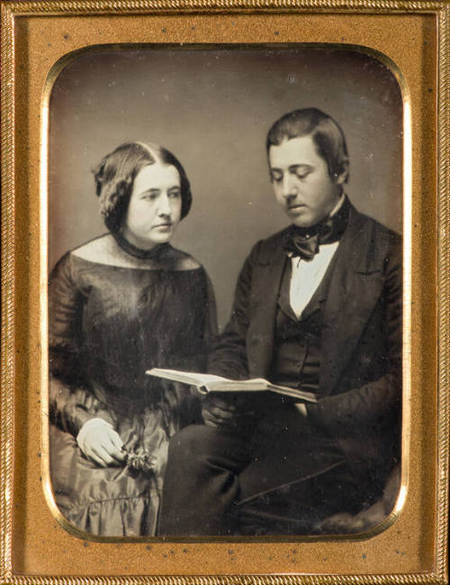 Man and woman reading a book