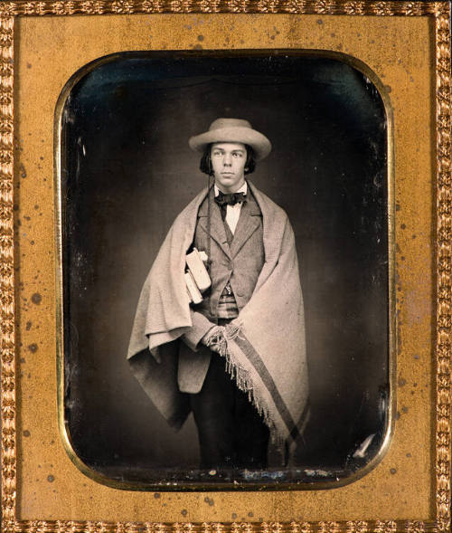 Schoolboy with shawl and books
