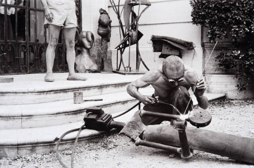 La Californie's front steps used as a workshop for the welder fitting a scepter into the mailed fist of Picasso's warrior king
