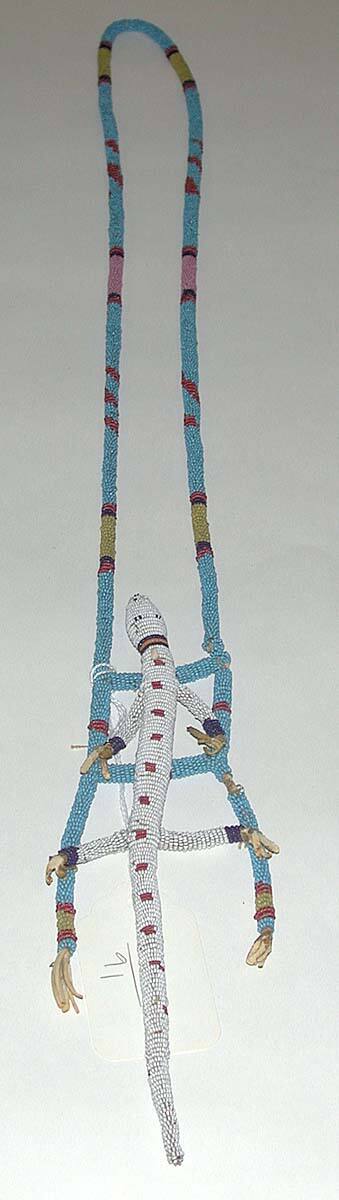 Beaded strand with attached beaded lizard