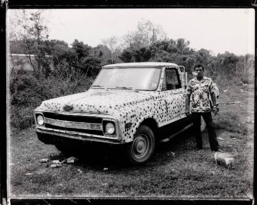 Man with cigarette and spotted truck, South Louisiana