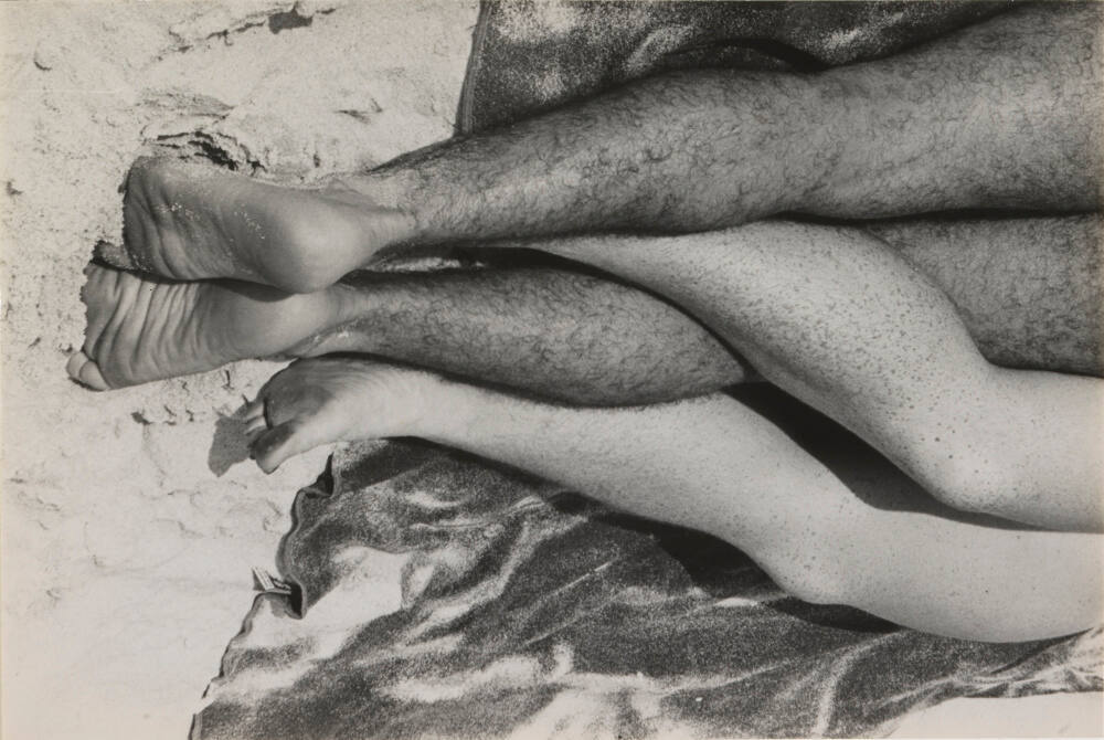 Untitled (legs entwined on beach)