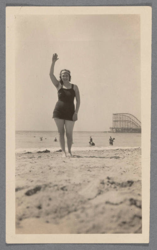Woman waving at beach