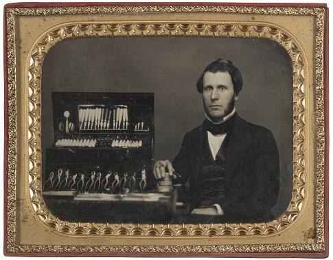 Dentist with Tools and Set of False Teeth