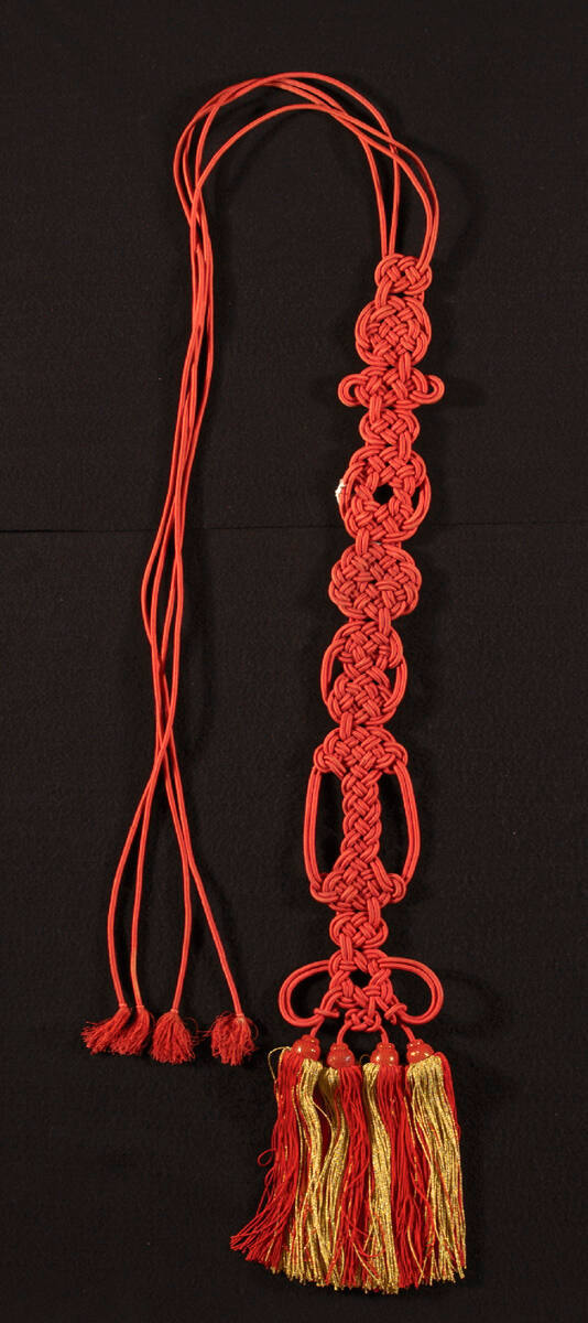Buddhist monk's tassels with gold and red stripes at bottom