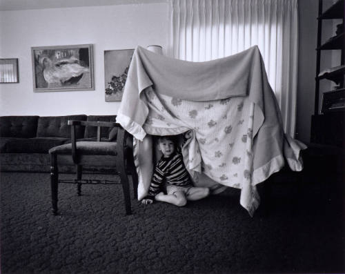 Some days when there is no one to play with I build Glenn a tent play house out of two chairs and two blankets.