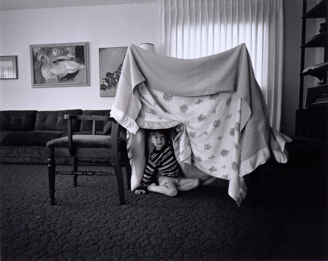 Some days when there is no one to play with I build Glenn a tent play house out of two chairs and two blankets.