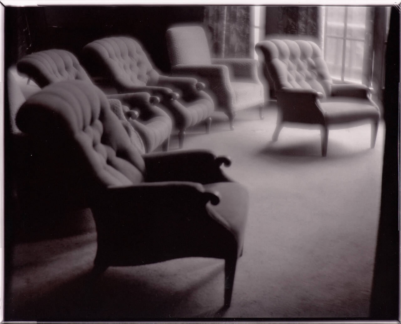 untitled (six overstuffed chairs in empty room)