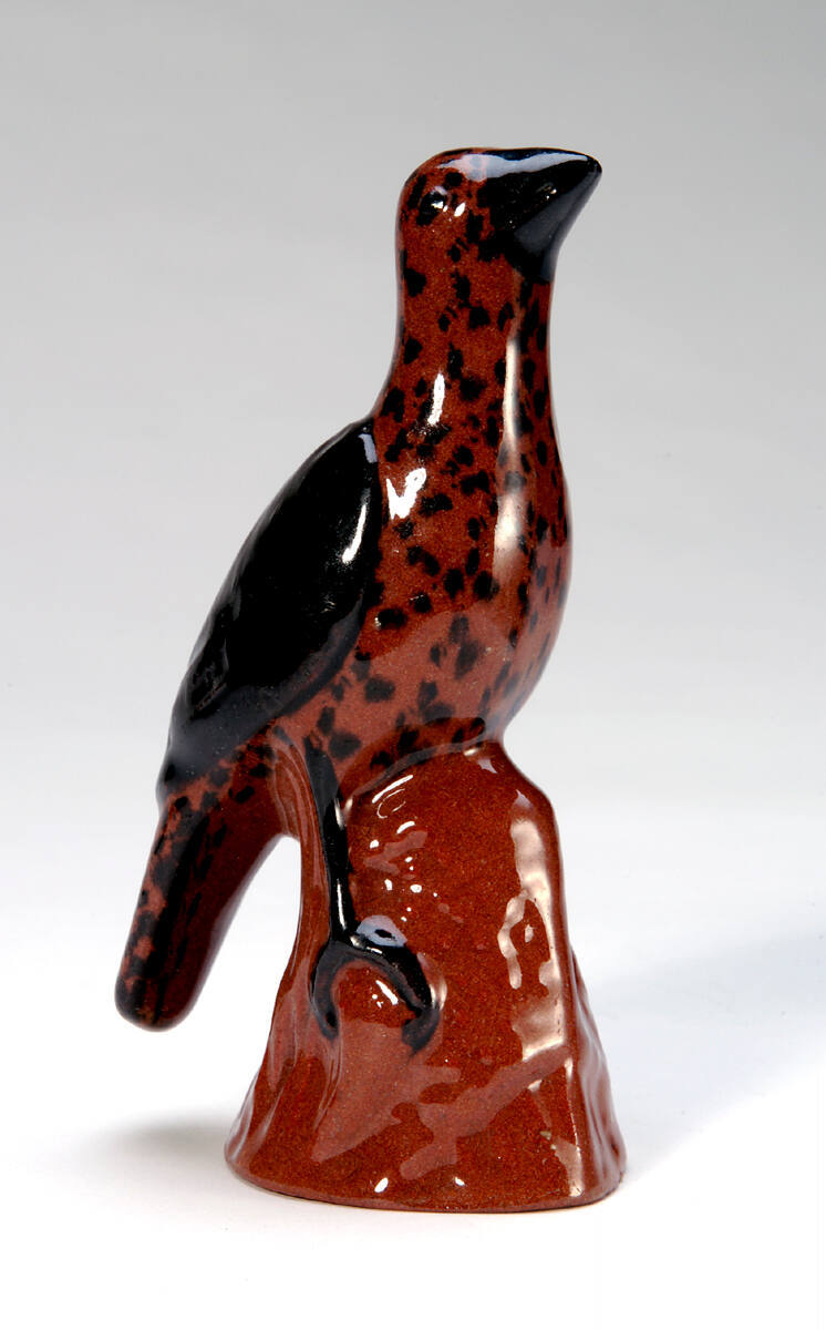 Figure of a Bird Standing on a Tree Trunk