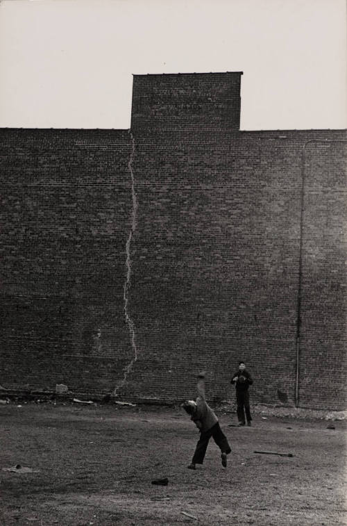 Untitled (Boys playing catch in empty lot)
