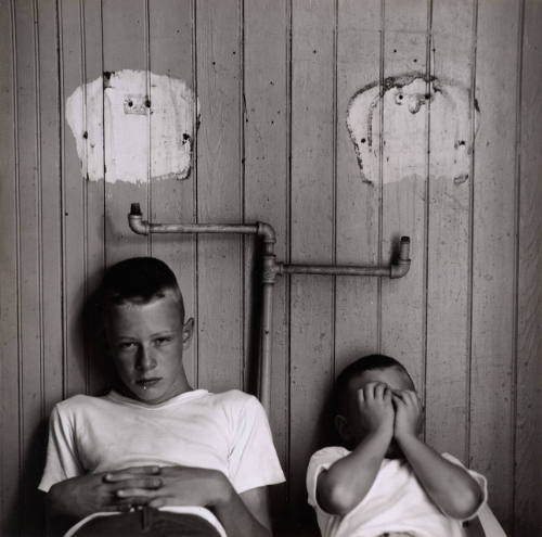 [Two boys with white spots over heads]