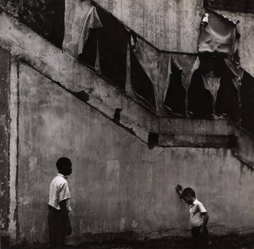 [Two boys in front of wall]