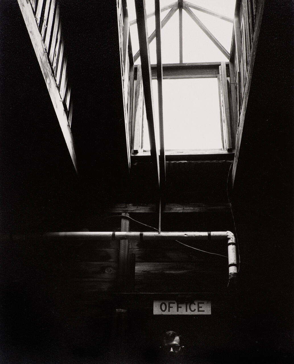 Self-portrait (under office sign)