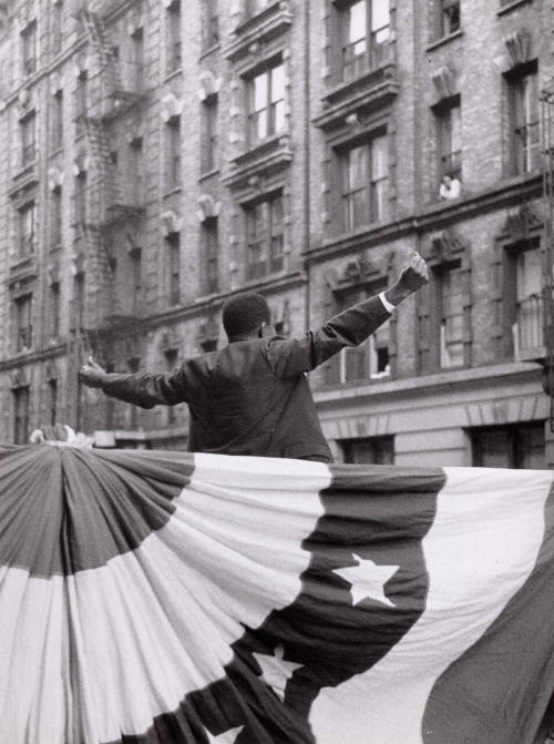 A black nationalist making a speech in middle of block, Harlem, New York