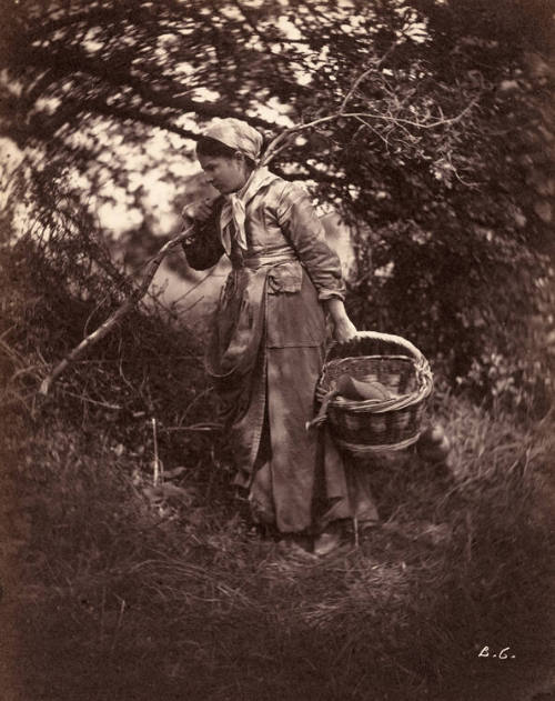 Woman standing with basket and branch
