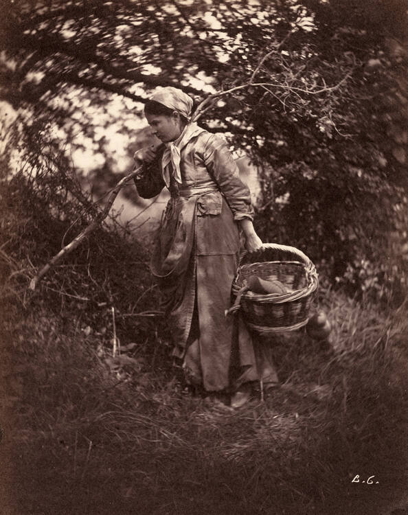 Woman standing with basket and branch