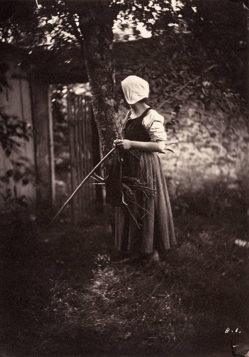 Woman with bundle of twigs