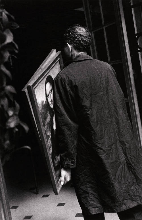 Man Carrying Framed Reproductions
