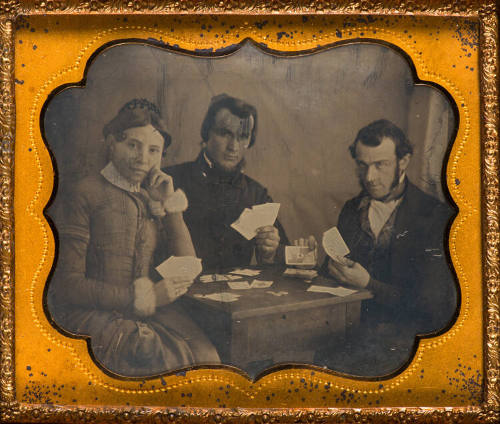 Woman and men playing cards