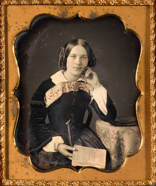 Woman holding copy of "Sunbeam and Shadows"