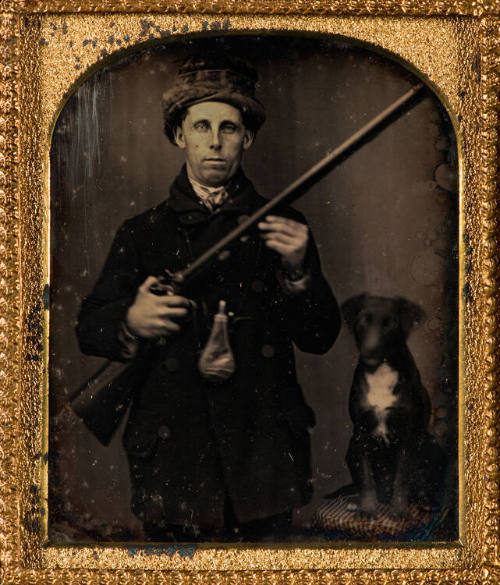 Hunter with rifle and dog