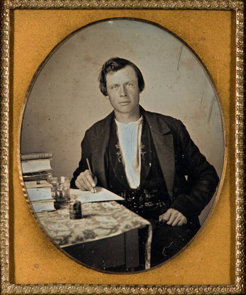 Man at desk, writing