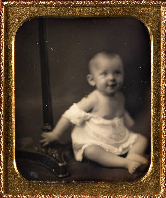 Infant sitting by headstand