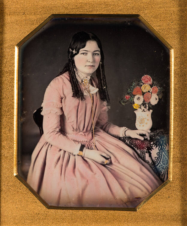 Woman seated, with flowers