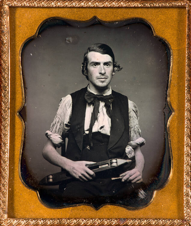 Portrait of man with weaving shuttle