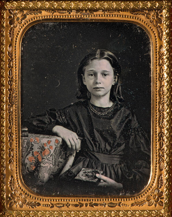 Girl holding daguerreotype case