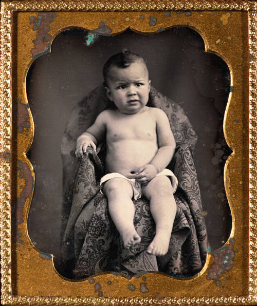 Naked boy in chair
