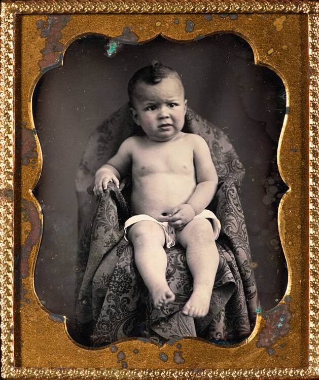 Naked boy in chair
