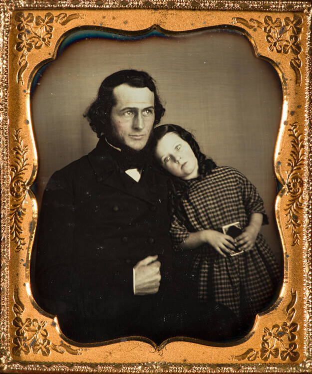 Man with daughter (girl holding a closed daguerreotype case)