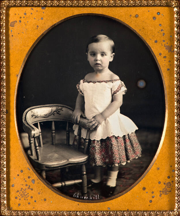 Portriat of a child with chair