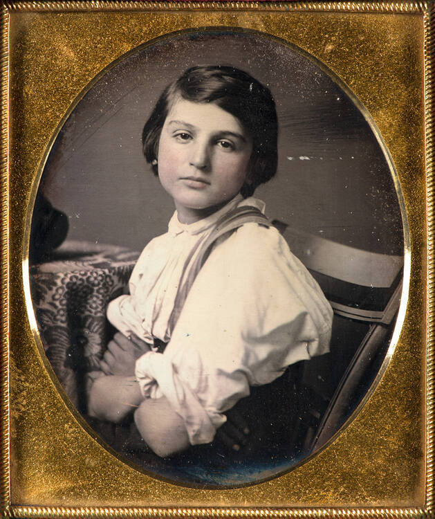 Child with sleeves rolled up
