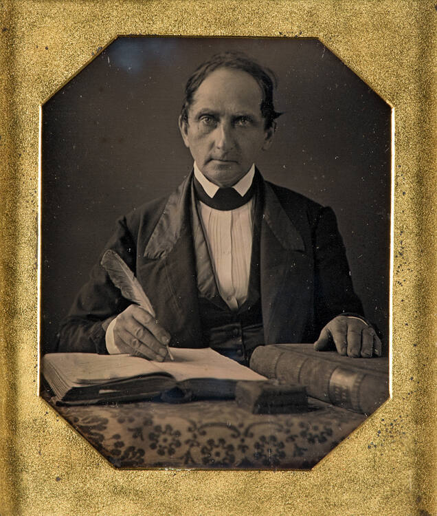 Man with quill pen and ledger book