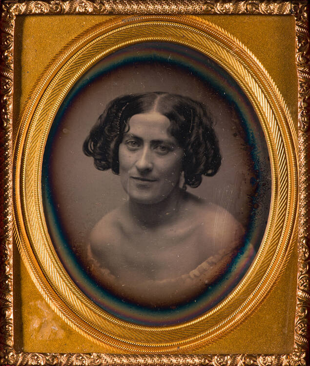 Bust portrait of a woman with ringlet styled hair