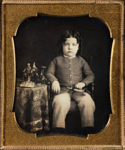 Boy with toys on table